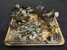 A quantity of assorted plated flatware, three-piece carving set, plated gravy boat,