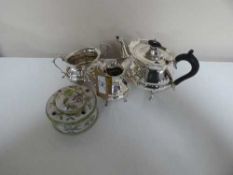 A three-piece Mappin & Webb silver plated tea service and a pottery china ink well