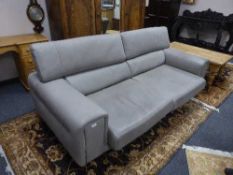 A contemporary Italian grey leather settee with adjustable head rests