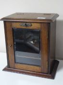 An Edwardian oak smoker's cabinet