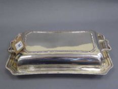A silver breakfast dish and cover, 1316g.