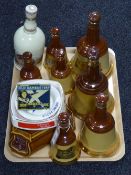 A tray of a quantity of Wade, Bells and Famous Grouse whisky decanters, some filled,