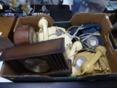A box of four bakelite telephones,