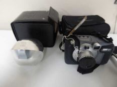 A Kodak DC 500 zoom digital camera and a Gomboc in leather case