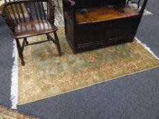 A fringed Ziegler carpet 190 cm x 140 cm on green ground