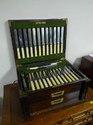 A mahogany brass bound canteen containing a set of stainless steel and plated cutlery by John