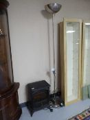 An electric fire in the form of a stove and a floor lamp