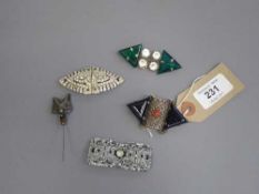 A sterling silver onyx Art Deco brooch together with two brooches,