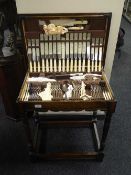 An oak cutlery table containing a John Sanderson & Son of Sheffield cutlery set