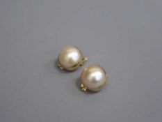 A pair of large mabe pearl earrings set in 18ct gold