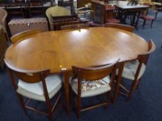 A mid 20th century teak drop leaf table and six stowaway chairs