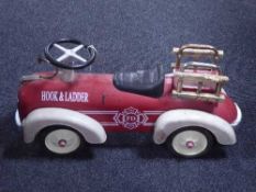 A child's hook and ladder fire department tin plate car