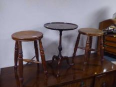 A pair of kitchen stools and a tripod wine table