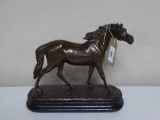 A spelter figure of a horse on wooden base