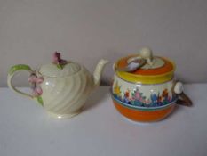 A Clarice Cliff lidded biscuit barrel and a Clarice Cliff teapot (2)