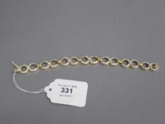 An 18ct gold diamond set bracelet, the seven principal stones each weighing approximately 0.