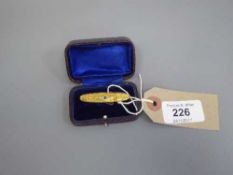 A 15ct gold Victorian bar brooch set with a small sapphire