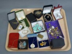 A silver jubilee ingot, costume jewellery, necklaces brooches etc.