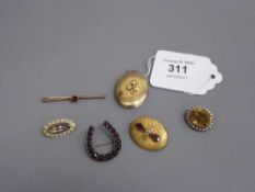 A collection of five Victorian brooches and a rolled gold locket.