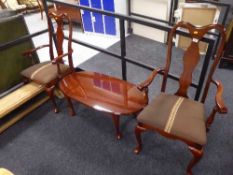 A pair of mahogany armchairs and an oval coffee table