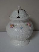 A Belleek 2004 annual piece lidded vase with flower decoration