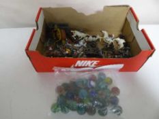 A box containing vintage glass marbles and assorted lead and plastic soldiers,