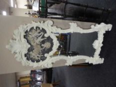 A white ornate mirror with a cherub relief plaque