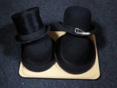 Three bowler hats together with a top hat