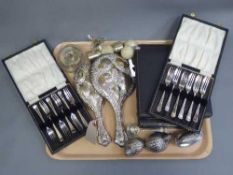 A silver backed mirror and dressing table brush together with four cases of silver plated cutlery,