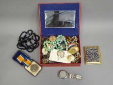 A jewellery box containing costume jewellery, British War Medal, compact,