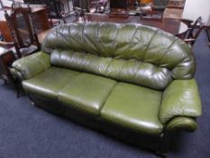 A green leather three seater settee
