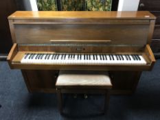 A teak-cased Baldwin over-strung piano, together with an adjustable piano stool.