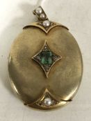 A Victorian oval shaped locket set with split pearls, rose cut diamond chips and a central emerald,