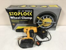 An 18 volt electric drill and a wheel clamp