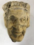 An antique stone carving of a head