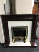 A contemporary electric fire in mahogany surround and a Vax vac cleaner