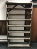 A large set of antique pine open bookshelves.