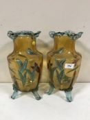 A pair of antique hand painted coloured glass vases