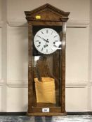 A good quality striking and chiming oak and burr olive wood regulator wall clock by Comitti of
