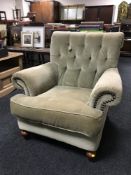 A Victorian style green button dralon armchair