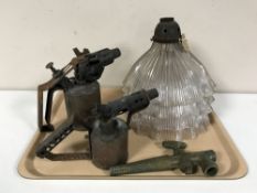 A vintage brass tap, two blow torches,