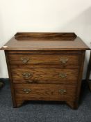 An oak three drawer chest with drop handles