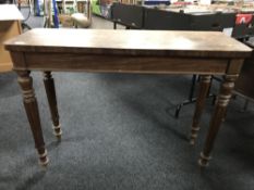 A Victorian mahogany hall table, on reeded legs.
