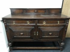 An early 20th century carved oak sideboard