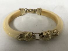A 1920's two-piece ivory bangle,