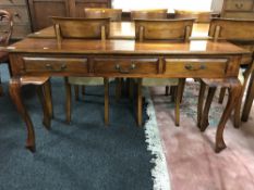 A contemporary hall table fitted three drawers