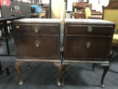 A pair of oak bedside cabinets .