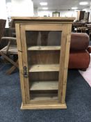 A pine glazed door curio cabinet