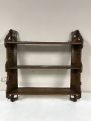 A carved oak wall shelf