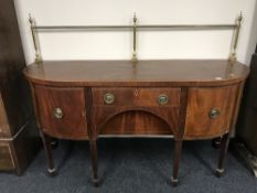 An inlaid mahogany bowfronted regency style sideboard with brass rail back